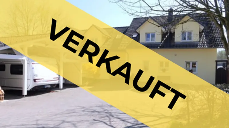 Verkaufte Immobilie: Wohnhaus mit Einfahrt und Banner „Verkauft“